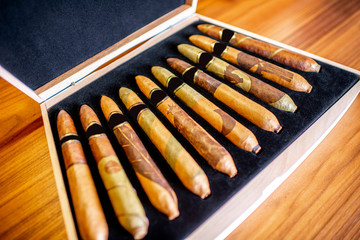 Close-up of luxury cigar set on the wooden table indoors