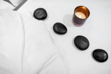 Close-up of black stones for massage on the towel indoors