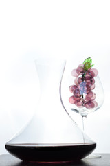 Italian red wine inside the decanter and goblet with decorations.