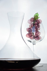 Italian red wine inside the decanter and goblet with decorations.