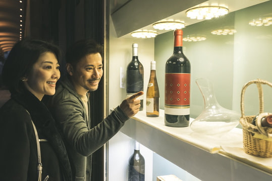 Asian couple shopping wine in barcelona
