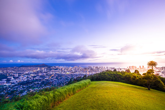 Tantalus Lookout at twilight, Puu Ualakaa State Park Honolulu. Tourists on panoramic city,Waikiki Beach and Diamond Head. Waikiki skyline Oahu Hawaii, United States. Vacation and travel concept.
