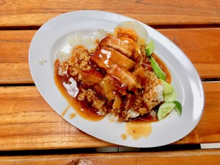 barbuced crispy pork in red sauce with rice - One of the most popular menu in this era of Thailand. Let's look at the hot rice, crispy pork with crispy salty red sauce.