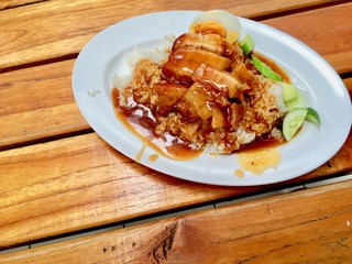 barbuced crispy pork in red sauce with rice - One of the most popular menu in this era of Thailand. Let's look at the hot rice, crispy pork with crispy salty red sauce.