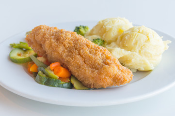 Chicken Kiev with vegetables and potatoes. Chicken breast with butter inside.