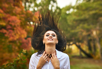 Hot white brunette in an autumn forest