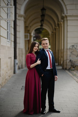 Young couple in a candid shot. They are walking in the street.