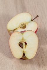 half of apple on wooden background
