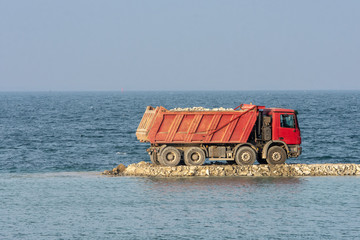 Fototapeta premium Truck with stone for the port construction