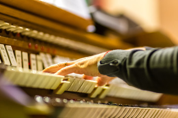 hands playing organ keyboard