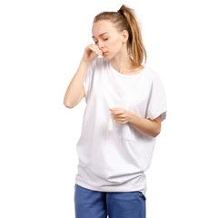 Fototapeta premium Beautiful woman is sick colds wipes nose on a white background. Isolation