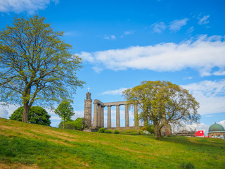 View of the National Monument of Scotland and the Nelson Monument, on Calton Hill in Edinburgh.