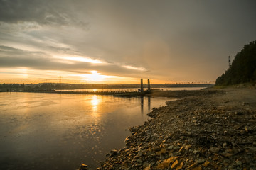 Pontoon crossing the river. Sunset