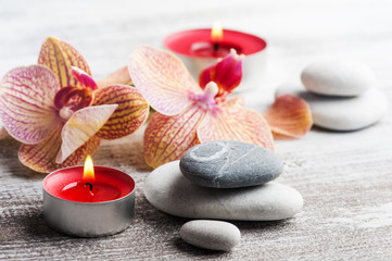 Spa still life with pebbles and red orange orchid