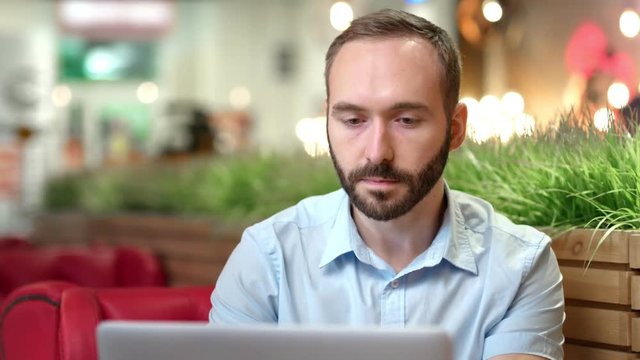 Portrait of pensive young businessman confident looking at screen using laptop