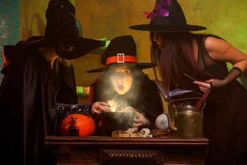 Image of three witches in hats cooking poison on cauldron