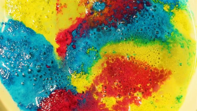 Chemical solution bubbles in colors of bright blues, reds and yellows in an abstract psychedelic liquid