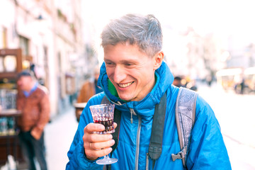 Man holding a glass of red wine.
