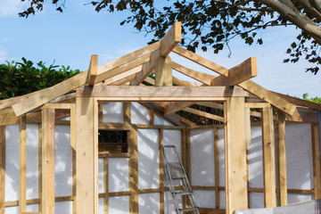 Building summer house or shed in the garden, wooden structure, waterproofed, on a stone base, selective focus
