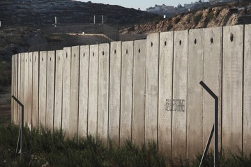 A section of the concrete Israeli West Bank barrier wall, with the world 