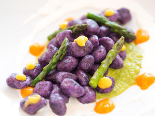 delicious food,  healthy pasta plate  italian purple potato gnocchi with asparagus and cream