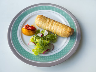 Baked cheese in batter with grilled vegetables on a plate.