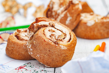 Homemade cottage cheese cookies with custard and walnuts on wooden background. Close up