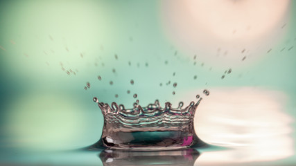 Drops of rain fall into the water, selective focus close-up