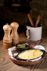 fish baked with cheese and salted cucumbers