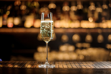 Glass of champagne standing on the bar counter © fesenko