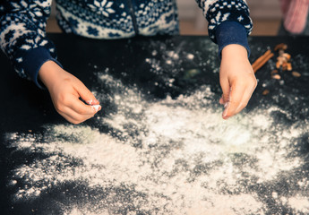 Happy family in the kitchen. Mother and child preparing the dough, bake cookies