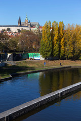 Colorful autumn Prague gothic Castle with the Lesser Town above River Vltava in the sunny Day,...