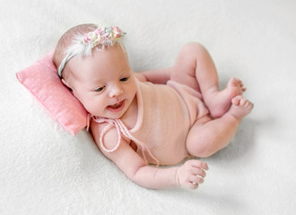 Little smiling baby joyfully lying