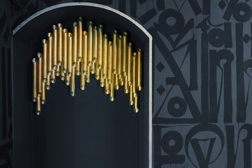 Golden tube on gray wall. Backgorund.Details of interior.