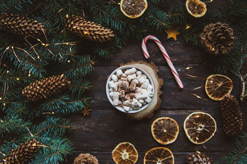Christmas background candy cane branches Hot Chocolate Beverage dried orange slices on dark background. Holiday card. Top view flat lay