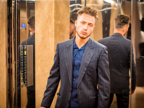 Handsome young man inside an elevator looking at camera