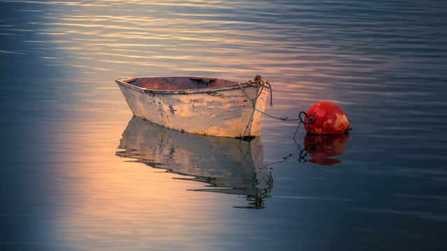 Row boat anchored at sunrise
