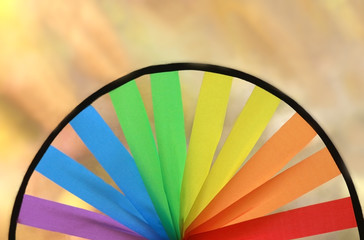half of a multi colored round pinwheel, bright background