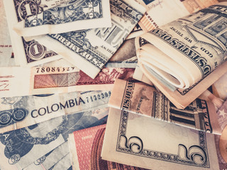 Cash money US Dollars and Colombian Pesos   - - obrazy, fototapety, plakaty