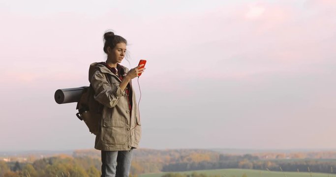 Hiker Woman taking photo smartphone photographing scenic landscape nature background view Hipster girl enjoying vacation travel adventure. 4K video