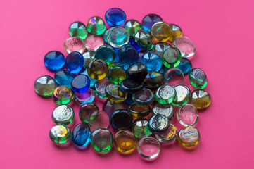 colorful beads on pink background