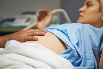 Doctor checking woman belly