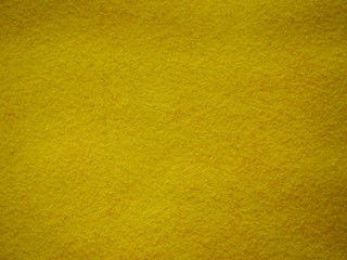 Fototapeta premium Yellow felt background, yellow texture