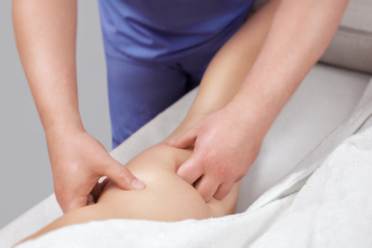 The masseur makes Anti-cellulite massage on the buttock and thighs of the patient. Treatment of excess weight.