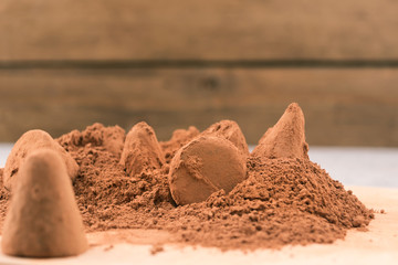 Fototapeta na wymiar Preparation of dessert-dip chocolate truffles in cocoa powder.