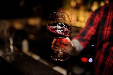 Professional bartender mixing wine in a glass