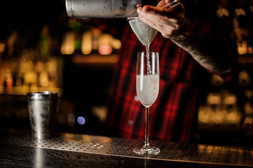 Barman making a fresh and tasty French 75 cocktail