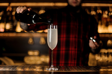 Bartender making a fresh and tasty French 75 cocktail