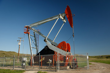 Fototapeta na wymiar Pump jack on oil field in southern Alberta in Canada
