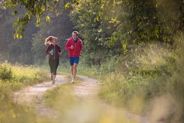 Photo sur Plexiglas Jogging young couple jogging along a country road